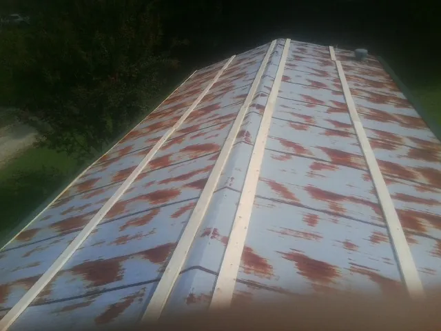 Rusted metal roof panels with new wood purlins before replacement — Storm Damage Roof Repair in Blackville by Roofing Brothers
